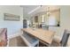 Cozy dining area features a rustic wooden table, comfortable seating, and soft lighting for Gathering meals at 740 Tanager Rd, Venice, FL 34293