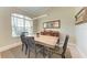 Dining room featuring a large window, modern light fixture, and a dining table set with four chairs at 740 Tanager Rd, Venice, FL 34293
