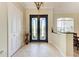 Open foyer features decorative glass double doors and tile flooring, creating a bright and inviting entryway at 740 Tanager Rd, Venice, FL 34293