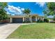 Charming single-story home boasts mature landscaping, a two-car garage, and a welcoming front entrance at 740 Tanager Rd, Venice, FL 34293