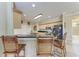 Stylish kitchen with black countertops, stainless steel appliances, and bamboo bar stools at 740 Tanager Rd, Venice, FL 34293