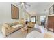 Bright and airy living room featuring vaulted ceilings, a ceiling fan, and a view of the dining area at 740 Tanager Rd, Venice, FL 34293