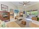 Bright and airy living room featuring vaulted ceilings, a ceiling fan, and sliding glass doors to the patio at 740 Tanager Rd, Venice, FL 34293