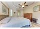 Comfortable main bedroom with bamboo accents, tray ceiling, and light wood flooring at 740 Tanager Rd, Venice, FL 34293