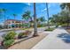 Beautiful street view featuring colorful buildings, lush greenery, and vibrant flowers on a sunny day at 740 Tanager Rd, Venice, FL 34293