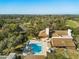 Overhead view of community pool, clubhouse, and well-maintained green spaces at 7515 Greystone Dr, Hudson, FL 34667