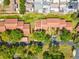 Overhead view of a single story condo in a landscaped residential neighborhood with mature trees and community green space at 7515 Greystone Dr, Hudson, FL 34667