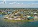 Wide aerial view of waterfront restaurant, parking, palm trees and the waterway at 7515 Greystone Dr, Hudson, FL 34667