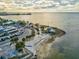 Stunning aerial view of a coastal restaurant, parking lot, and waterfront at 7515 Greystone Dr, Hudson, FL 34667
