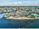 Expansive aerial view of the coastal neighborhood, waterway, and beachside restaurant at 7515 Greystone Dr, Hudson, FL 34667