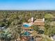 Overhead view of community pool, tennis court, clubhouse, park, and play area at 7515 Greystone Dr, Hudson, FL 34667