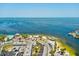 Breathtaking aerial view of the coastline showcasing the clear blue water, sandy beach, and local businesses at 7515 Greystone Dr, Hudson, FL 34667
