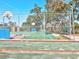 A view of the basketball court with green and red-painted surface and chain-link fence enclosure at 7515 Greystone Dr, Hudson, FL 34667