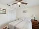 Comfortable bedroom with a bed, a ceiling fan, and a closet, offering a cozy retreat at 7515 Greystone Dr, Hudson, FL 34667