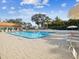 Large community pool with lounge chairs, umbrellas, and a spacious deck area at 7515 Greystone Dr, Hudson, FL 34667