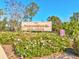 Beacon Woods Civic Center sign amidst blooming flowers and lush greenery at 7515 Greystone Dr, Hudson, FL 34667