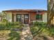 Charming single-story home featuring a welcoming front porch, walkway, and a beautiful yard at 7515 Greystone Dr, Hudson, FL 34667