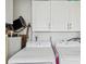 Efficient laundry room featuring a Samsung washer and dryer, complemented by white cabinets for storage at 7515 Greystone Dr, Hudson, FL 34667