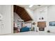 Bright and open living room with a vaulted ceiling, fireplace, and views of the landscaped community at 7515 Greystone Dr, Hudson, FL 34667