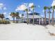 View of covered picnic pavilions on the beach with picnic tables and BBQ grills at 7515 Greystone Dr, Hudson, FL 34667