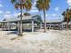 Outdoor picnic pavilions with tables and BBQ grills along the beach and views of the water at 7515 Greystone Dr, Hudson, FL 34667