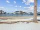 Scenic waterfront view showcasing calm water, surrounding homes, and clear blue skies at 7515 Greystone Dr, Hudson, FL 34667