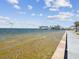 Scenic waterfront view of a residential area on the coast with clear water and a walking path at 7515 Greystone Dr, Hudson, FL 34667
