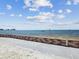 View of the waterfront with a seawall and clear blue water with a small boat at 7515 Greystone Dr, Hudson, FL 34667