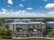 Aerial view of colorful condominium complex with mature trees and ample parking on a sunny day at 8403 Placida Rd # 205, Placida, FL 33946
