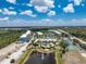 Beautiful aerial view of the community featuring the pool, tennis courts and lush surroundings at 8403 Placida Rd # 205, Placida, FL 33946