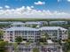 Sprawling community featuring multiple multi-story buildings, lush trees, well-manicured landscaping, and ample parking at 8403 Placida Rd # 205, Placida, FL 33946