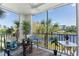 Screened-in balcony with outdoor seating overlooking a waterfront view at 8403 Placida Rd # 205, Placida, FL 33946