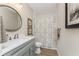 Charming bathroom featuring a vanity with a marble countertop and a shower with a patterned curtain at 8403 Placida Rd # 205, Placida, FL 33946