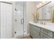 Modern bathroom featuring a glass-enclosed shower and a vanity with a grey marble countertop at 8403 Placida Rd # 205, Placida, FL 33946