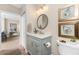 Stylish bathroom with a grey vanity, a marble countertop, and a shower with a patterned curtain at 8403 Placida Rd # 205, Placida, FL 33946