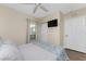 Comfortable bedroom featuring a ceiling fan, flat-screen TV, and neutral decor at 8403 Placida Rd # 205, Placida, FL 33946
