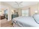 Bright bedroom featuring wood floors, ceiling fan, stylish dresser and decor, and a door to another room at 8403 Placida Rd # 205, Placida, FL 33946