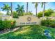 Landscaped entrance to the Cape Haze Resort, featuring a decorative sign, flowers, and lush greenery at 8403 Placida Rd # 205, Placida, FL 33946