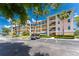 Condominium building with balconies, palm trees, and parking in a coastal community at 8403 Placida Rd # 205, Placida, FL 33946