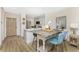 Kitchen and dining area with blue chairs, hardwood floors and modern white countertops at 8403 Placida Rd # 205, Placida, FL 33946