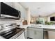 Open kitchen area with stainless appliances and view to living and dining area at 8403 Placida Rd # 205, Placida, FL 33946