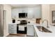 Updated kitchen with stainless steel appliances, light-colored cabinetry and marble countertops at 8403 Placida Rd # 205, Placida, FL 33946