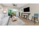 Comfortable living room with balcony and TV at 8403 Placida Rd # 205, Placida, FL 33946