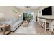 Cozy living room with a ceiling fan and access to the outdoor balcony at 8403 Placida Rd # 205, Placida, FL 33946