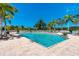 Sparkling pool surrounded by palm trees and lounge chairs, perfect for relaxation and leisure at 8403 Placida Rd # 205, Placida, FL 33946