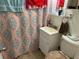 Compact bathroom with patterned shower curtain, sink, and toilet at 8629 Aero Ave, North Port, FL 34287