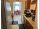 Kitchen showcasing wood cabinets and a view into the dining room at 8629 Aero Ave, North Port, FL 34287