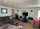 Living room with a large sectional couch, tv, and hardwood floors at 8629 Aero Ave, North Port, FL 34287
