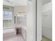 Bathroom with tub, vanity and walk-in closet at 863 Macaw Cir, Venice, FL 34285