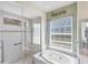 Bright bathroom featuring a tub, a shower, and a large window at 863 Macaw Cir, Venice, FL 34285